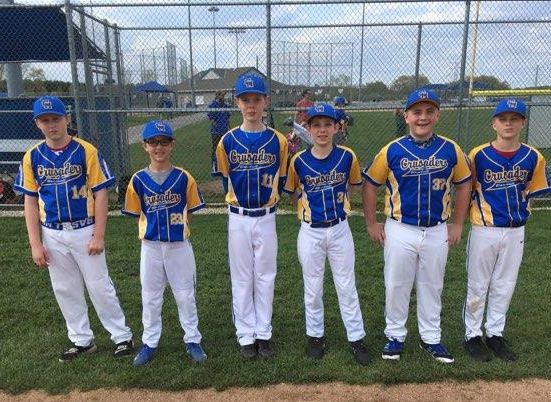 Junior Crusader Baseball team stands in the field